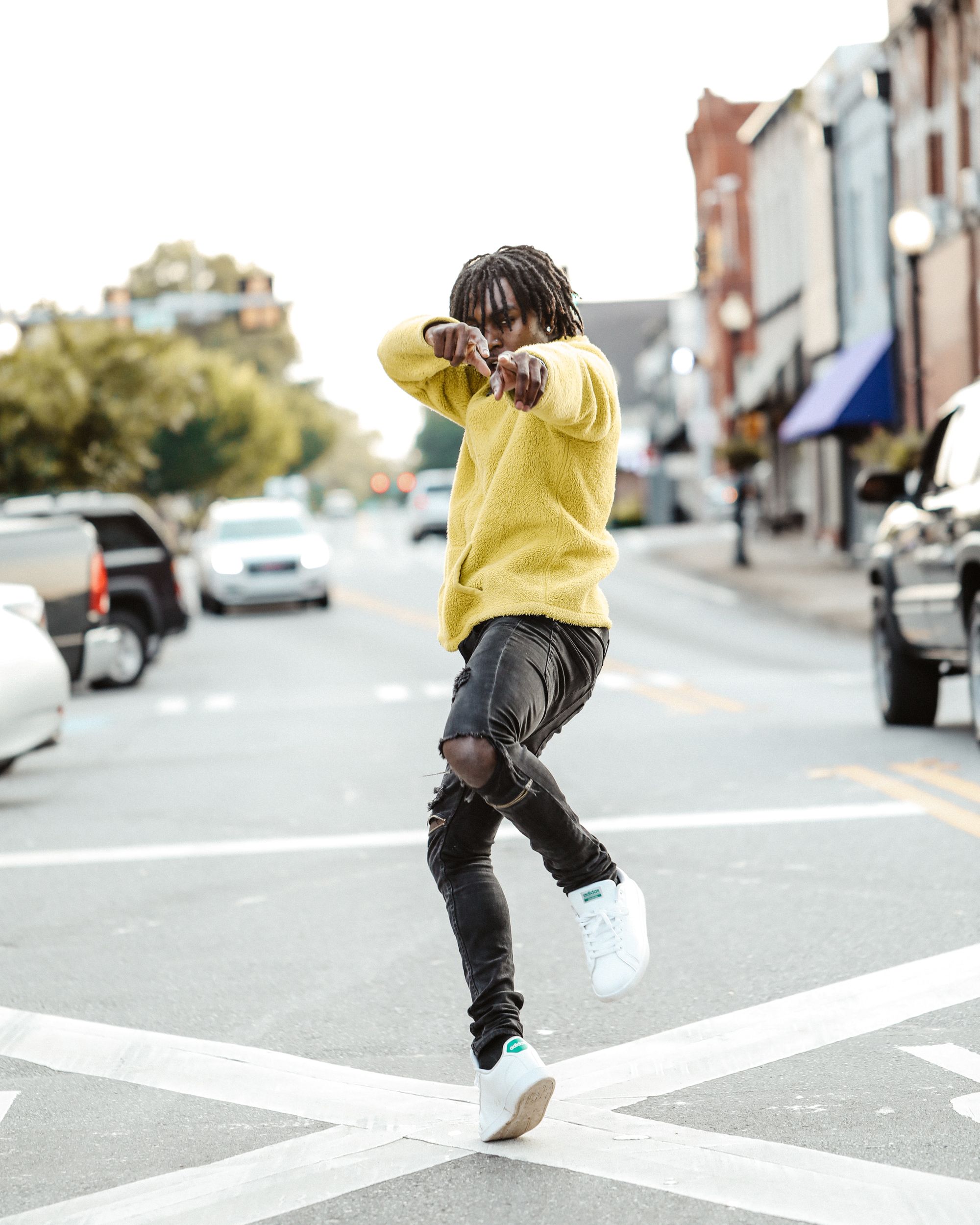 Man pointing to camera, dancing alone