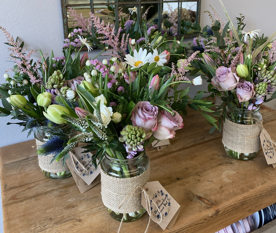 Rustic bouquets on a wooden table, by Sue Lawrence