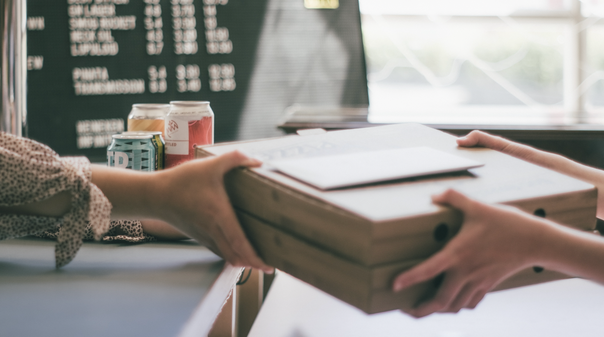 Hands exchanging boxes in a small business